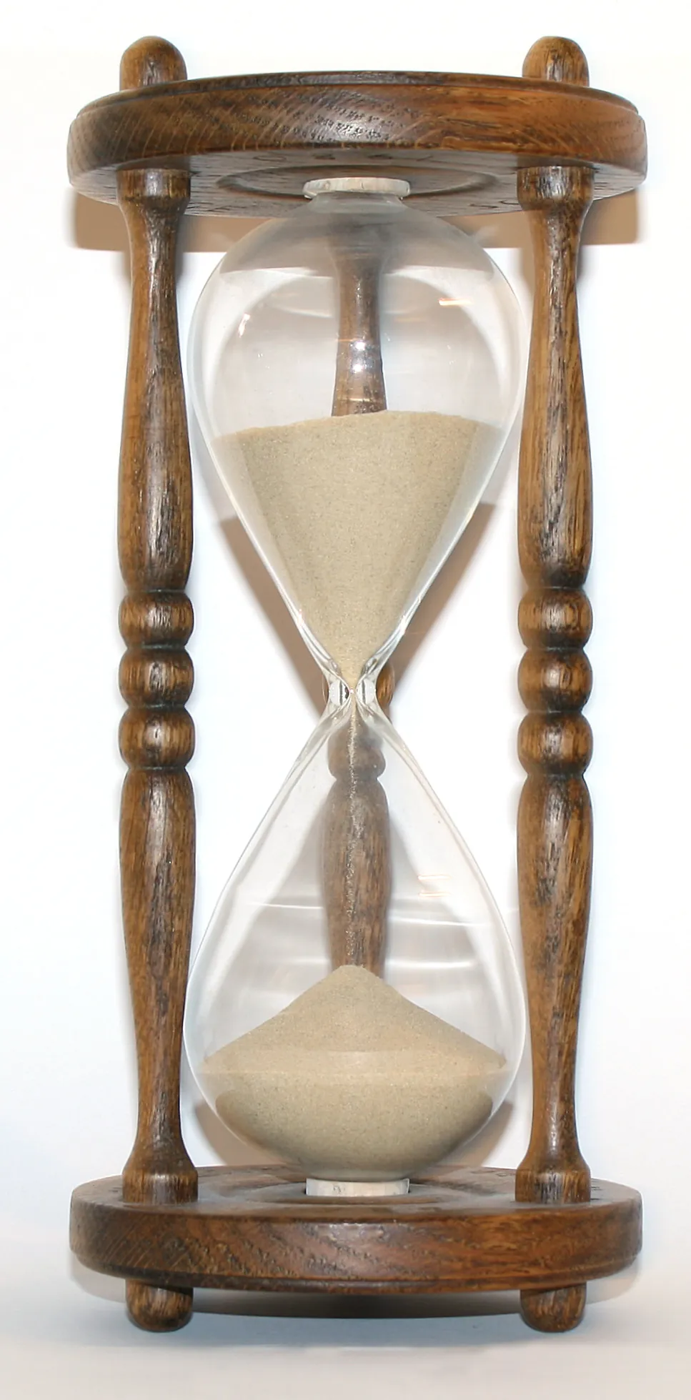 A wooden hourglass on a table